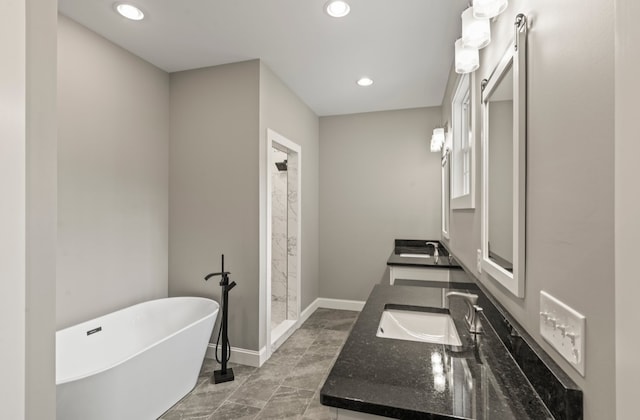 bathroom featuring tile patterned flooring, vanity, and separate shower and tub