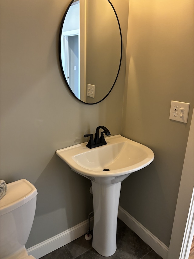 bathroom featuring tile patterned flooring and toilet