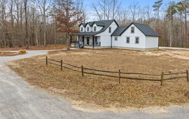 new england style home with a porch