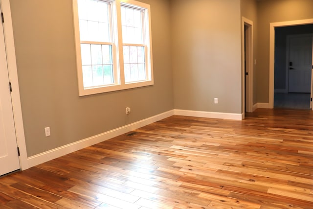 empty room with light hardwood / wood-style flooring