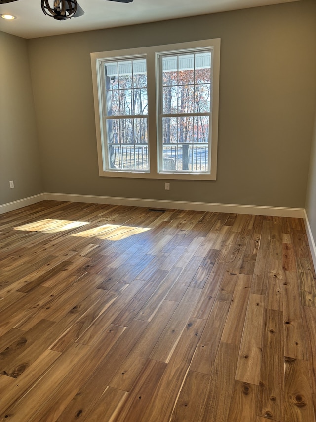 unfurnished room featuring hardwood / wood-style flooring and ceiling fan