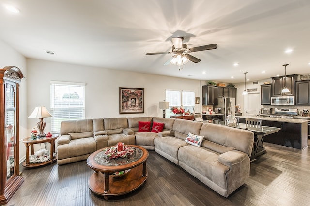 living room with dark hardwood / wood-style floors and ceiling fan