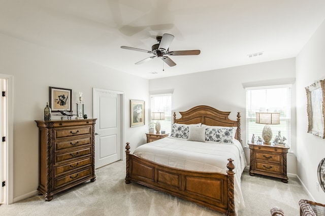 bedroom with ceiling fan and light colored carpet