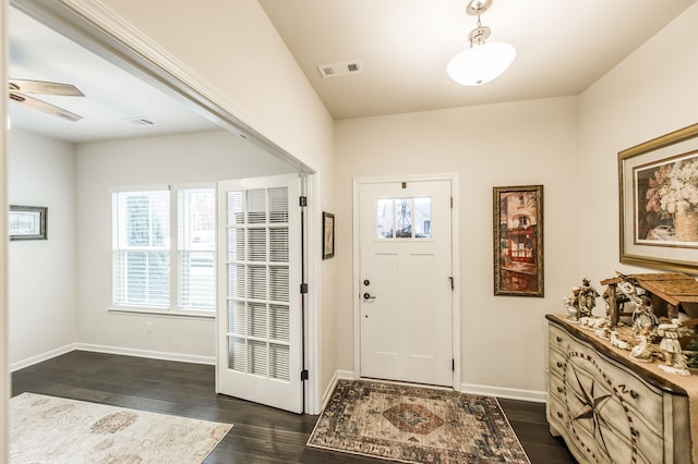 entrance foyer with ceiling fan and dark wood-type flooring