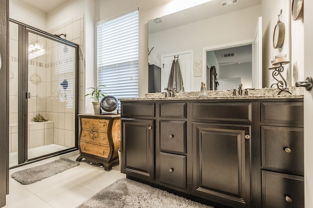 bathroom with tile patterned flooring, vanity, and a shower with shower door