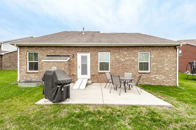 rear view of property with a yard and a patio