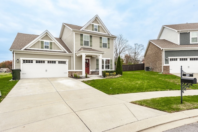 craftsman inspired home with a front yard, a garage, and central air condition unit