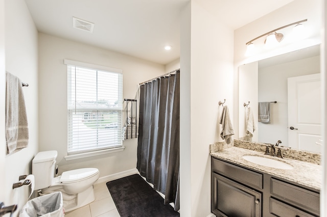 bathroom featuring tile patterned floors, vanity, and toilet