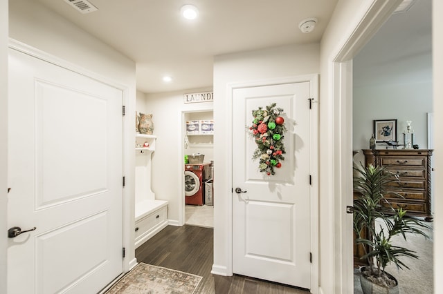 mudroom featuring dark hardwood / wood-style floors and washing machine and clothes dryer