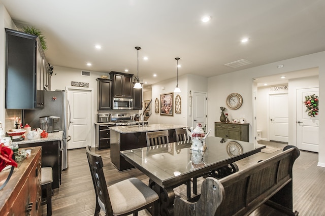 dining room featuring hardwood / wood-style floors and sink