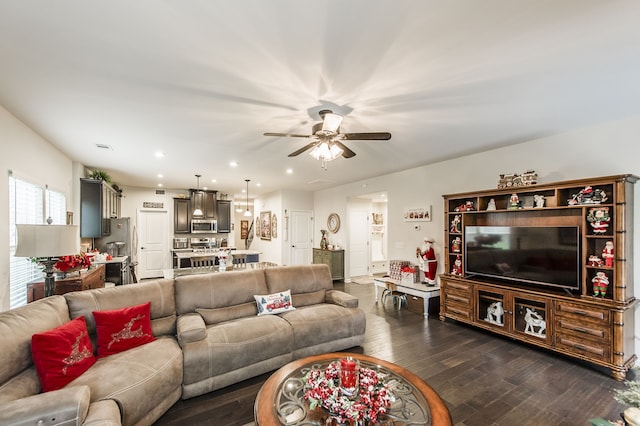 living room with ceiling fan and dark hardwood / wood-style floors