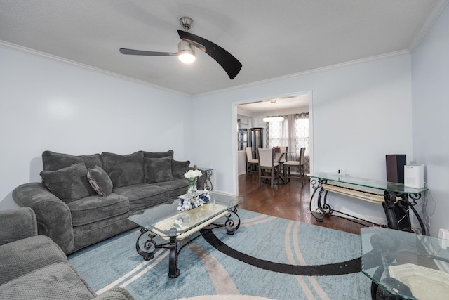 living room featuring dark hardwood / wood-style flooring, ceiling fan, and crown molding