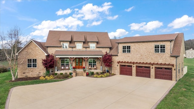 view of front of property featuring covered porch and a garage