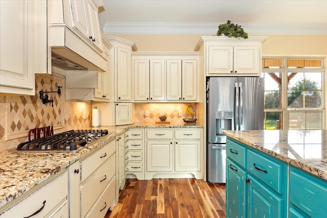 kitchen with decorative backsplash, dark hardwood / wood-style flooring, stainless steel appliances, blue cabinets, and crown molding