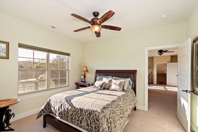 bedroom with ceiling fan and light colored carpet