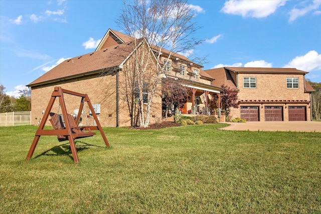 exterior space featuring a playground, a front yard, and a garage