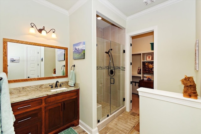 bathroom with vanity, wood-type flooring, a shower with door, and ornamental molding