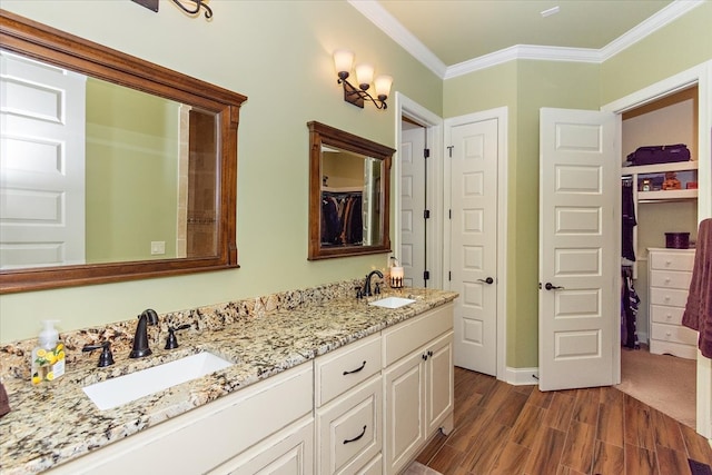 bathroom featuring hardwood / wood-style floors, vanity, and crown molding