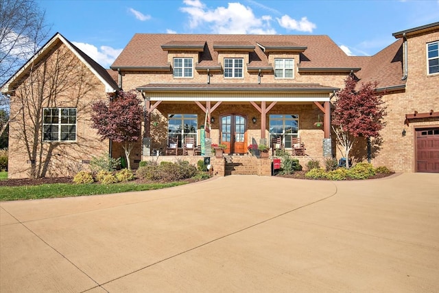 view of front facade with a porch and a garage