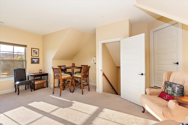 dining area featuring light carpet