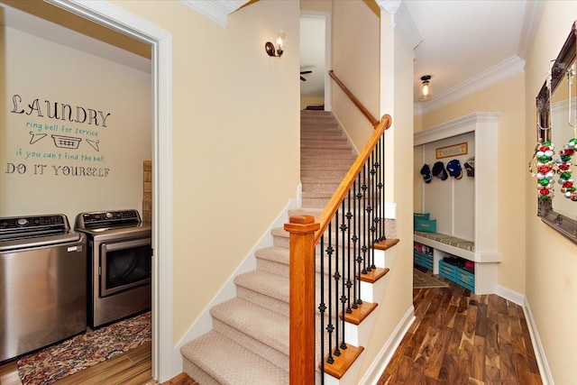 stairs with washer and dryer, hardwood / wood-style floors, and ornamental molding