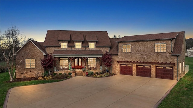 view of front of property with a porch and a garage