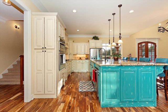 kitchen featuring a wealth of natural light, a large island, and decorative light fixtures