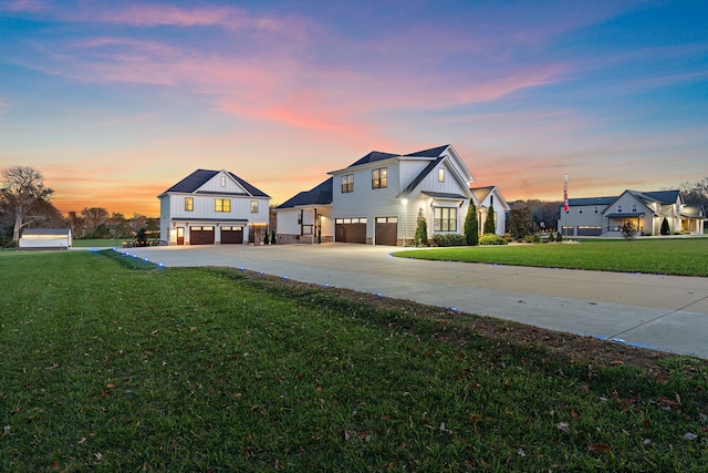 view of front of property with a garage and a yard