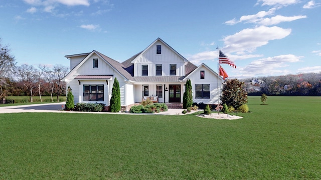 modern farmhouse with covered porch and a front yard