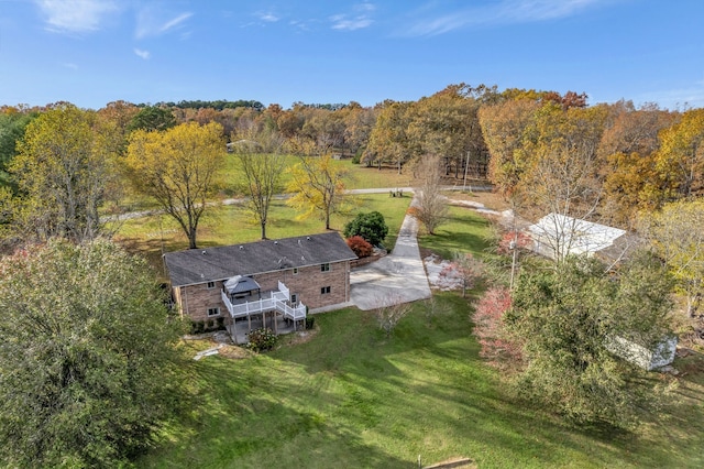 birds eye view of property with a view of trees