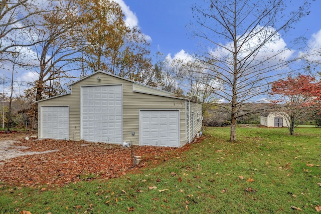 garage featuring a lawn