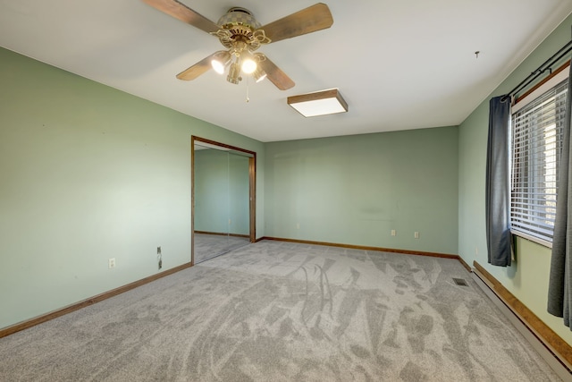 spare room with ceiling fan, carpet flooring, visible vents, baseboards, and baseboard heating