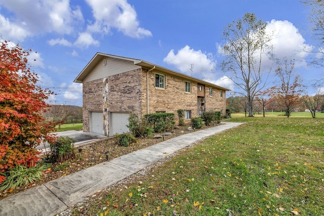 view of side of property with concrete driveway, a yard, brick siding, and an attached garage