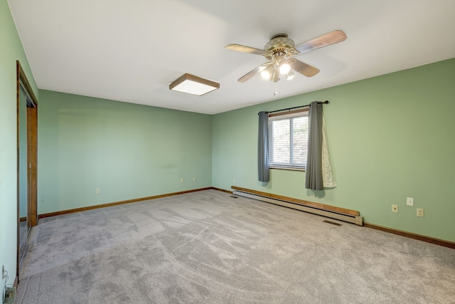 empty room featuring light carpet, ceiling fan, and a baseboard heating unit