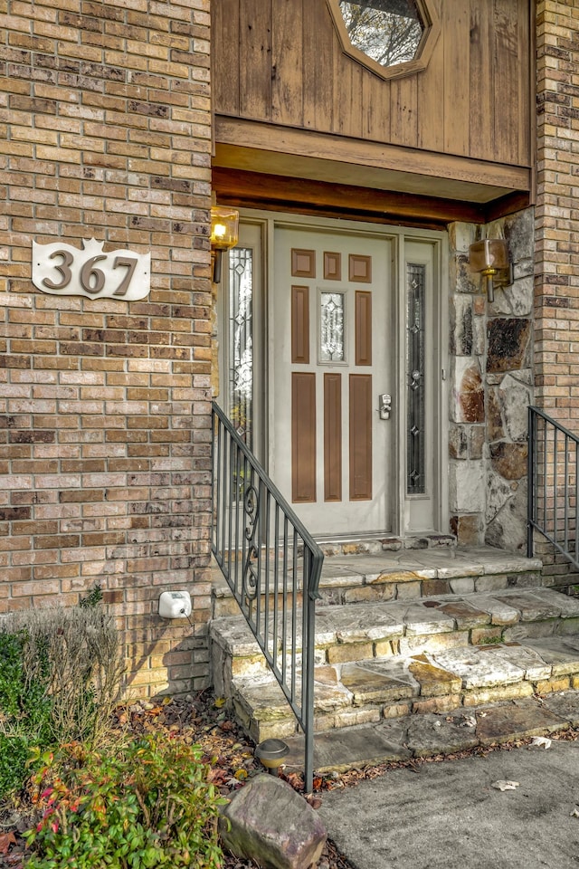 property entrance with brick siding