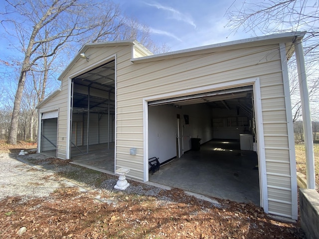 garage with dirt driveway