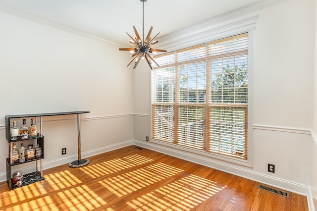 interior space featuring ceiling fan, hardwood / wood-style floors, and ornamental molding