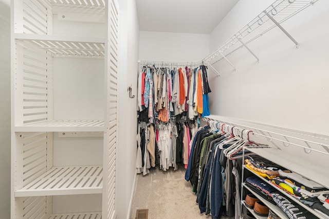 walk in closet featuring carpet floors