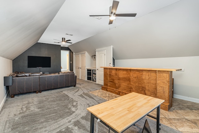 carpeted living room featuring ceiling fan and lofted ceiling