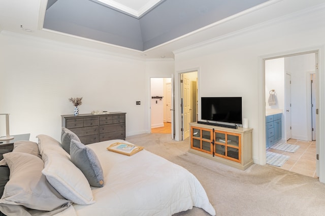 carpeted bedroom featuring ornamental molding and ensuite bath