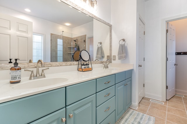 bathroom with tile patterned flooring, vanity, and an enclosed shower