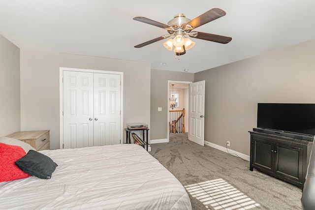 carpeted bedroom featuring ceiling fan and a closet