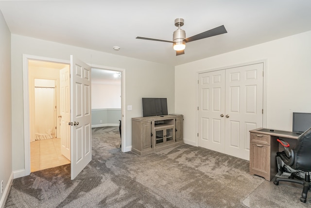 office space featuring dark carpet and ceiling fan