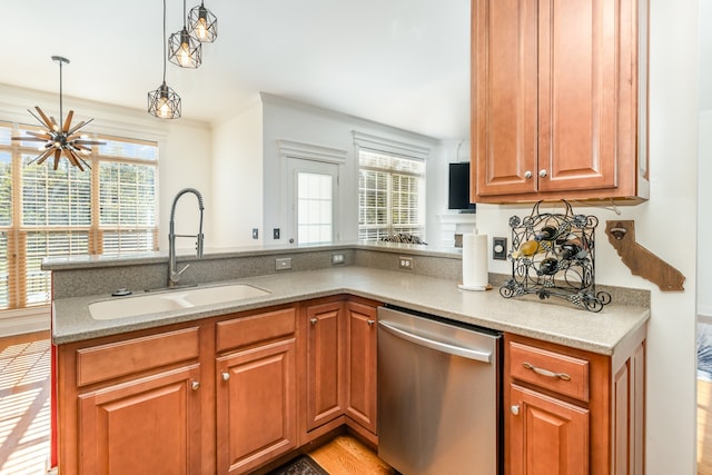 kitchen featuring dishwasher, decorative light fixtures, a wealth of natural light, and sink