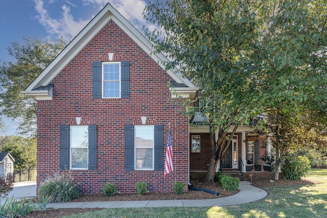 view of front of property with covered porch and a front yard