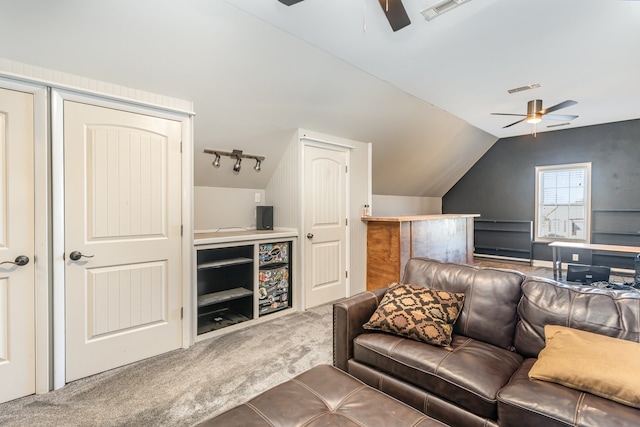 carpeted living room featuring ceiling fan and vaulted ceiling