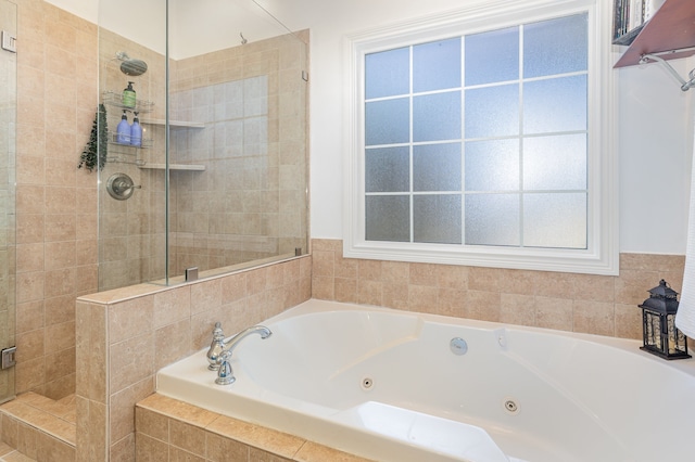 bathroom featuring plenty of natural light and plus walk in shower