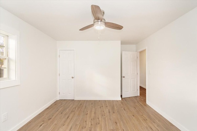 empty room with ceiling fan and light wood-type flooring