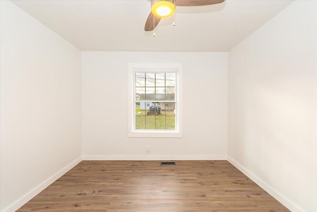 spare room featuring ceiling fan and hardwood / wood-style flooring