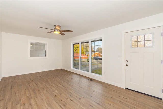 foyer with ceiling fan and light hardwood / wood-style floors